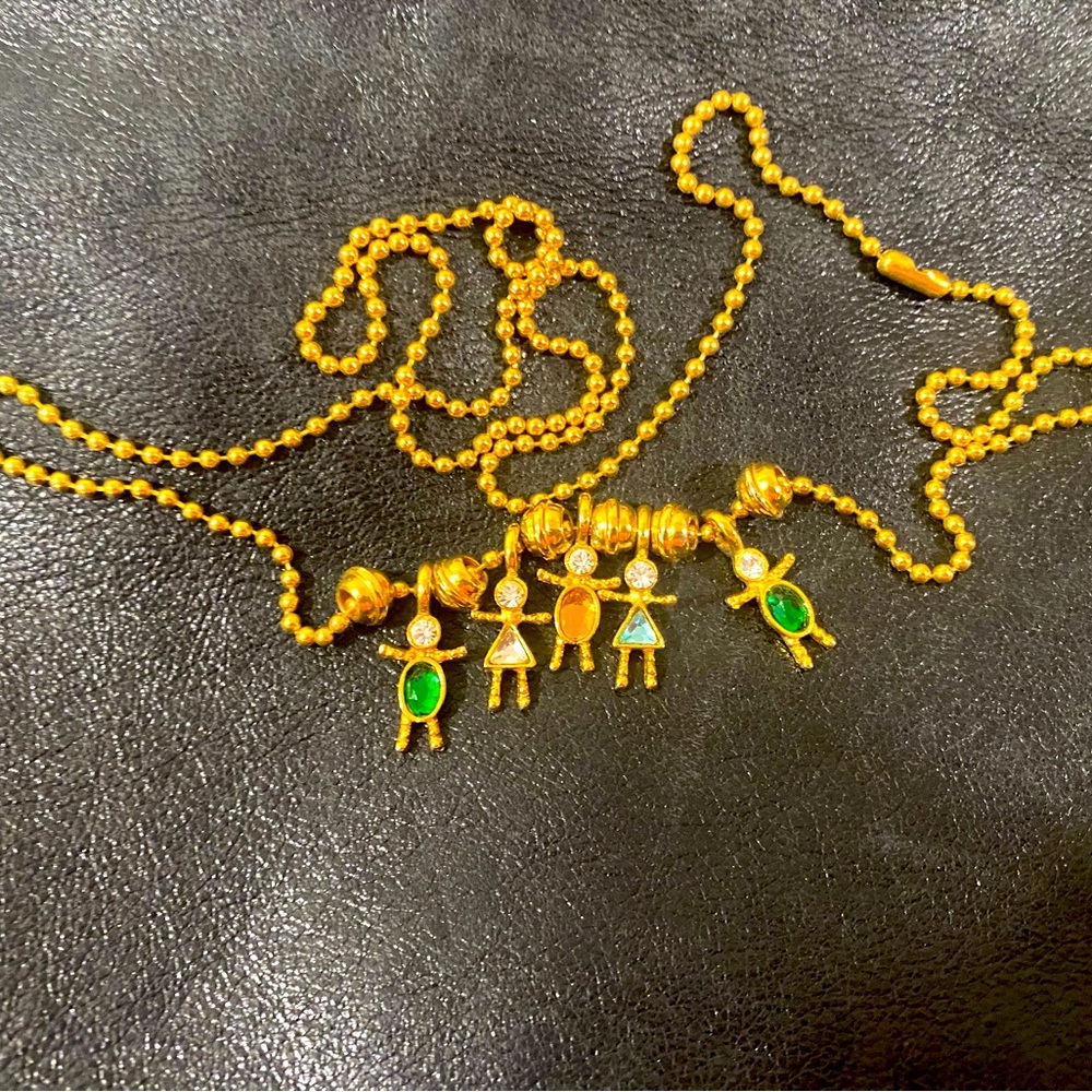 Charm gold tone necklace with rainbow figurines